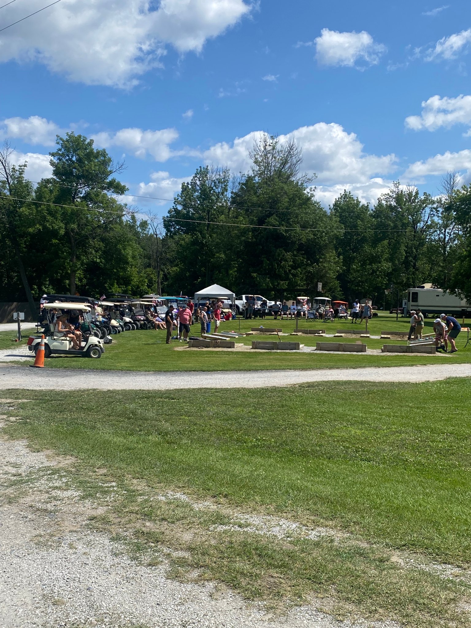 Cornhole tournament with golf carts and guests